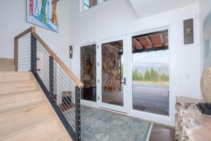 a staircase in a house with sliding glass doors at Blue Moon Challet in Big Sky Mountain Village
