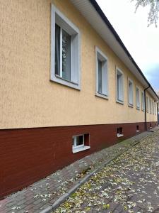 a building with windows on the side of it at Seven Hotel VIP in Korostenʼ