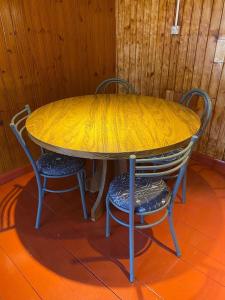 a table with two chairs with a yellow sheet on it at Casa Prusia, tipica de pioneros europeos in Aristóbulo del Valle