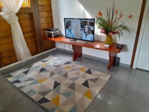a desk with a computer on it in a room at Gîte Ti Roucou in Petit-Bourg