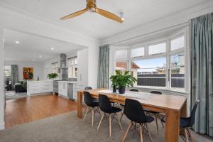 a kitchen and dining room with a table and chairs at Clyde on Sunderland in Clyde
