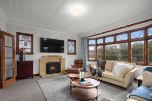 a living room with a couch and a fireplace at Clyde on Sunderland in Clyde