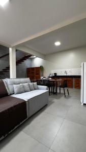 a large living room with a couch and a table at Chalés da Bica - Modernidade e Aconchego a 100m da Praia in Paracuru