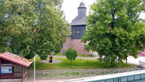 a building with a tower with a clock on it at RJS Lambach GbR, Ferienwohnung am Dorfplatz in Waldkappel