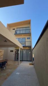 a large building with a walkway in front of it at Chalés da Bica - Modernidade e Aconchego a 100m da Praia in Paracuru