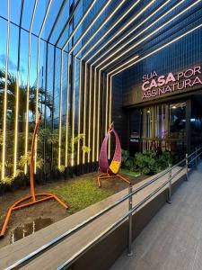 a building with a bench in front of a store at Tolive One - Ilha do Leite, Recife in Recife