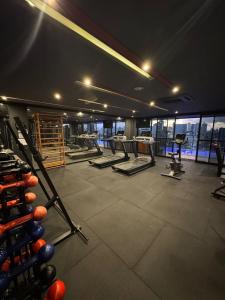 a gym with a row of treadmills and machines at Tolive One - Ilha do Leite, Recife in Recife
