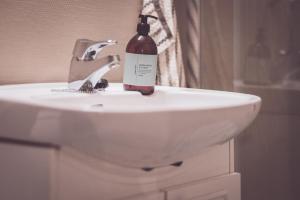 a bottle of wine sitting on top of a sink at Modern Flat In Tromsø Centre in Tromsø +26 photos