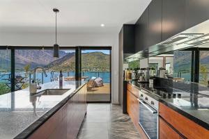 a kitchen with a view of a mountain at Charming Lakeview Home ! in Queenstown