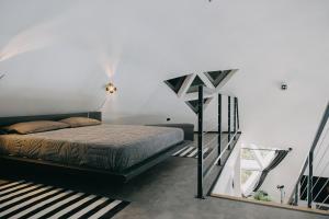 a bedroom with a bed and a staircase at Dome Noire in Puškarič Selo