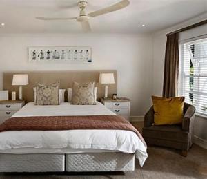 a bedroom with a bed and a ceiling fan at The Pointe Taveuni in Matei