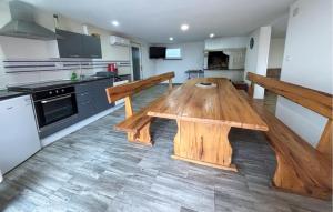 a kitchen with a wooden table in the middle at Cozy Home In Tinjan in Tinjan