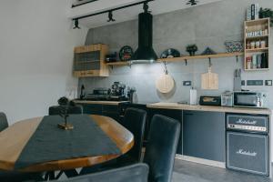 a kitchen with a table and chairs in a room at Dome Noire  +12 photos