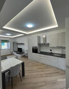 a large kitchen with a table and chairs in it at Cantalupo 3 in Cantalupo