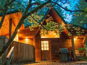 a log cabin with a door in front of it at Almost Paradise Lodging in Ashford