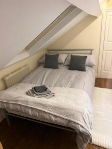 a white bed with a pile of clothes on it at Collin street in Nottingham