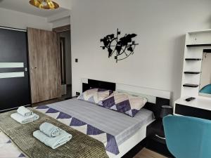a bedroom with a bed and a blue chair at 18th & 16h Floor Secure Luxury Condos With Pool & Fitness Included In Price in Skopje +59 photos