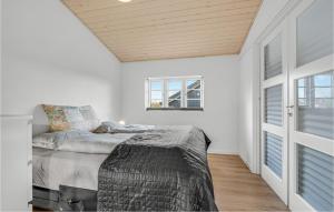 a white bedroom with a bed and a window at Stunning Home In Sydals With Sauna in Skovbyballe