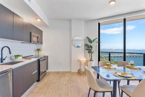a kitchen with a table and a dining room with a view at MVR Luxury King Suite Overlooking Biscayne Bay in Miami