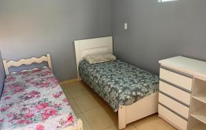 Un dormitorio pequeño con una cama y una cómoda. en Charcara JJC, en Arapiraca