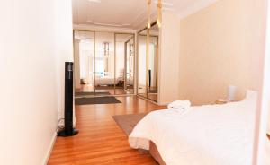a bedroom with a white bed and a mirror at Iconic 2 Bedroom Apartment in Tangier
