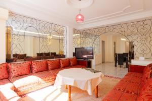 a living room with a couch and a tv at Iconic 2 Bedroom Apartment in Tangier