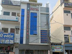 a building with a sign on the side of it at Hotel O The Ferns in Thānesar
