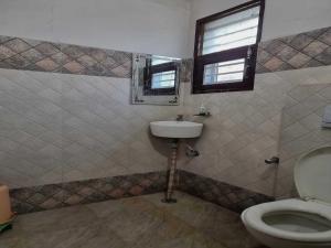 a bathroom with a sink and a toilet at Hotel O The Ferns in Thānesar