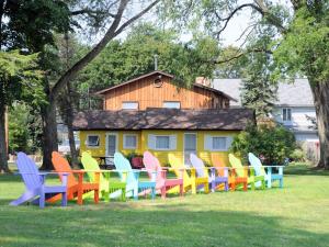 a group of colorful chairs sitting in the grass at Firefly Beach in Huron +18 photos
