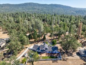 an aerial view of a house in the trees at Cedar Creek Lodge with POOL/hot tub/sleeps 24! in Oakhurst