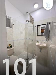 a bathroom with a shower and a toilet and a sink at Hotel Casa Alom in Cali