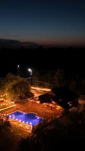 a large pool with blue lights at night at Ranč Lipe in Orašje
