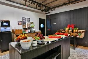 a buffet with many plates of fruit on a table at CONFORT iNN JARDINS in São Paulo
