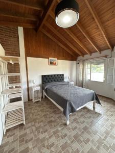 a bedroom with a bed and a wooden ceiling at Agosto 23 in Mina Clavero +15 photos