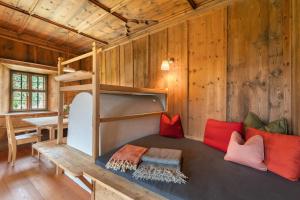a room with a bunk bed in a cabin at Ansitz Baumannhof Apt 1818 in Falzes