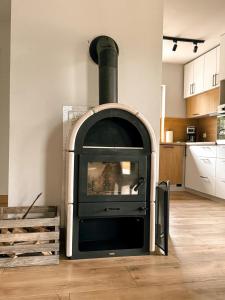 d'un salon avec une cheminée et une cuisine. dans l'établissement Apartamenty Brzozowe, à Okoniny Nadjezierne