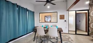 une salle à manger avec une table et des chaises blanches dans l'établissement Loft Colibrí, à Ciudad del Carmen