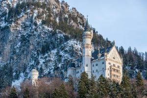 a castle sitting on top of a mountain at Ferien Bei Mari in Schwangau
