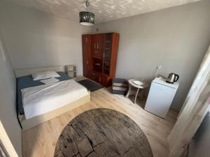 a small bedroom with a bed and a table at Noclegi Maria in Chełm