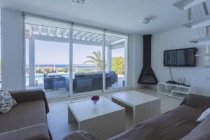 a living room with a view of the ocean at V196 Villa Brisa in Son Bou