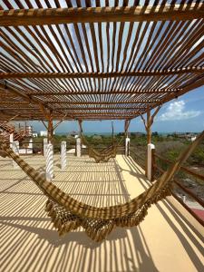 een hangmat op een terras met uitzicht op de oceaan bij Casa del Sol Holbox - Self Check In in Holbox Island