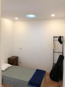 a bedroom with a bed and a black suitcase at Consciência Viva in Encarnação +25 photos