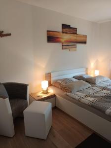 a bedroom with a bed and a couch and a chair at Die Wohnung Stein in Bretzfeld