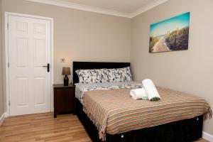 a bedroom with a bed with two pillows on it at RB home Stockport in Stockport +21 photos