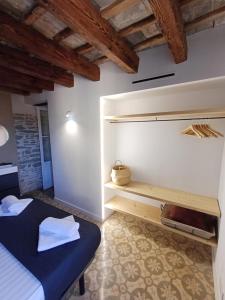 a bedroom with a bed in a room with wooden ceilings at FeelhomeVIC. Ático con terraza en centro histórico in Vic