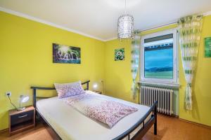 a bedroom with a bed and a window at Haus Loks in Sankt Märgen