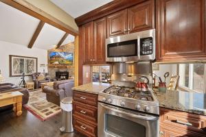 a kitchen with a stove and a microwave at Four Diamond Escape in Seven Devils