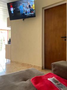 a living room with a flat screen tv on the wall at Departamentos Don Julio in Guaraní