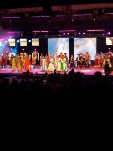 a group of people on a stage in front of a crowd at Departamentos Don Julio in Guaraní
