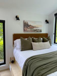 a bedroom with a large bed with white sheets at Coastal A-Frame, Near Schoodic Point, Acadia in Gouldsboro